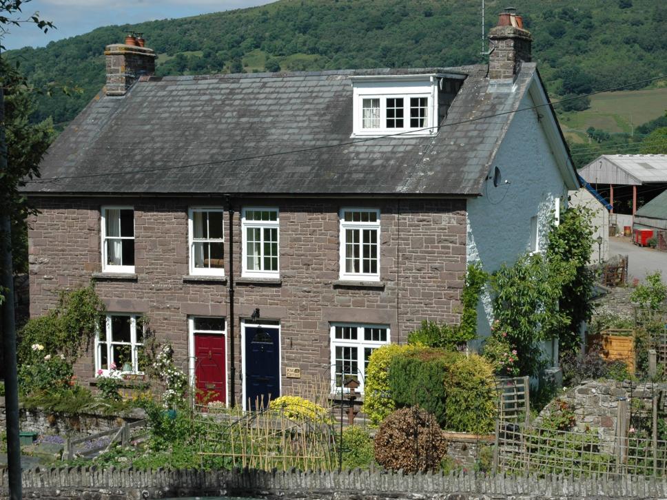 Canal View Cottage is a traditional cottage, situated on the right with the blue door